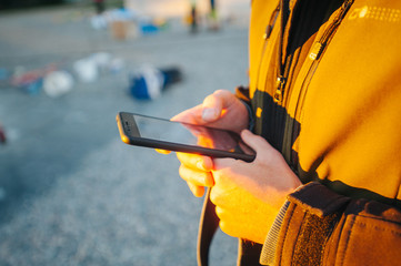 Freedom and active lifestyle concept. Man using smartphone at street.