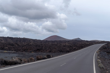 Road crossing volcanic terrain, Lanzarote Island, Canary Islands, Spain