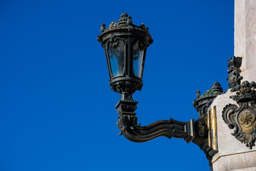 Fototapeta na wymiar Old street lamp at The Marquess of Pombal Square (Praca do Marques de Pombal). Lisbon, Portugal