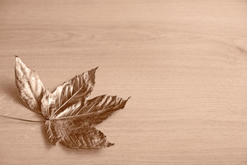 golden leaves on wooden background