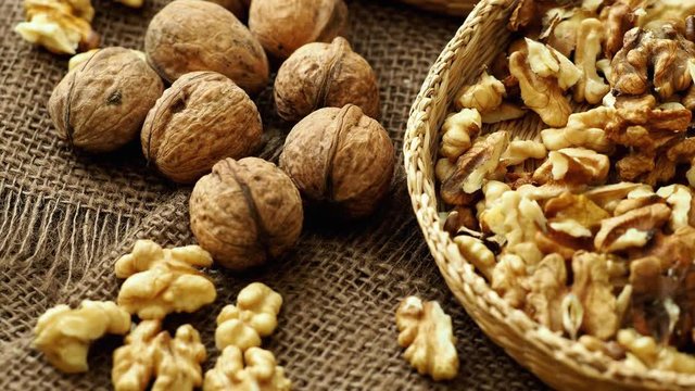 Walnuts on rustic natural burlap, Walnut kernels in wicker basket, Walnut background