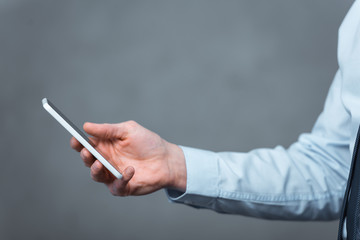 cropped image of businessman using smartphone in office