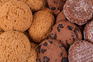 Background from different sweet cookies. Oatmeal cookies and chocolate. top view close up