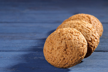 oatmeal cookies piled in a pile on a blue wooden table. bake. tasty plan