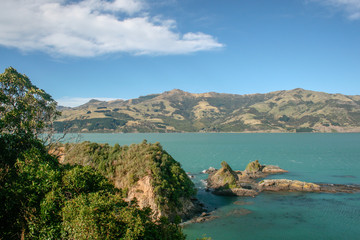 Landscape of ocean, rocks and hills in Banks Peninsula, Christchurch, Canterbury, New Zealand
