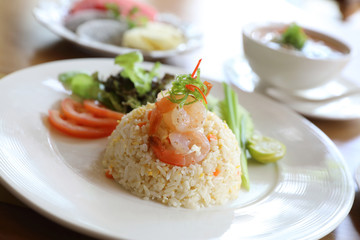 Fried rice with shrimp on wooden table