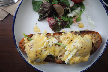 Egg benedict , poached eggs with toast on wood background , English Breakfast