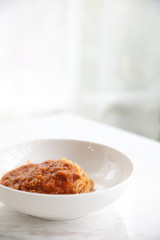 spaghetti Bolognese with minced beef and tomato sauce garnished with parmesan cheese and basil , Italian food