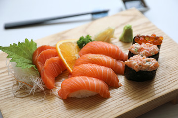 Salmon sushi and sashimi on wood plate Japanese food