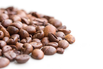 Roasted coffee beans isolated on a white background.