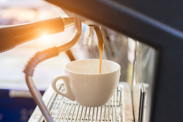Coffee maker with coffee cup.