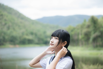 Portrait of asian japanese school girl costume looking at park outdoor film vintage style