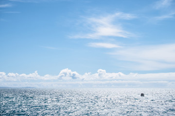View of the boat on the sea. blue sky and cloud over the sea.