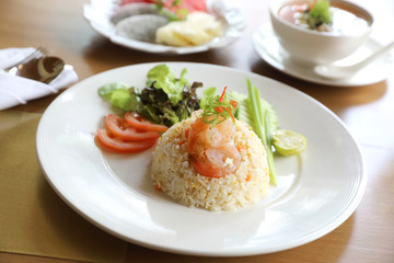 Fried rice with shrimp on wooden table