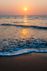 Fototapeta na wymiar Sunset sun above the Arabian sea beach in Kochi, India.