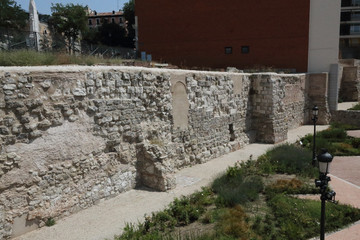 The remains of the old, brick and stone made Arabic walls (Muralla Arabe) in Madrid, Spain