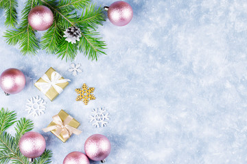 Festive Christmas background with fir branches, giftboxes, silver and golden decorations, copy space