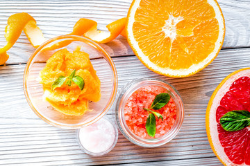 organic cosmetic with citrus on wooden background top view