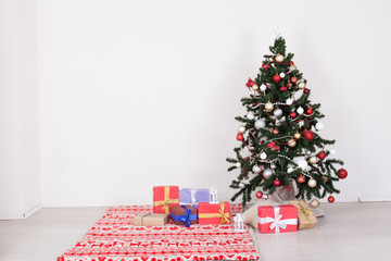 Green Christmas tree with white toys new year winter gifts decor