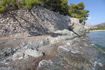 sea coast with stones and wall