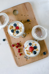 Healthy breakfast from yogurt and fresh berries in a jar. Top view, flat