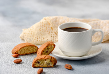 Good morning concept - breakfast frothy espresso coffee accompanied by delicious Italian almond cantuccini biscuits