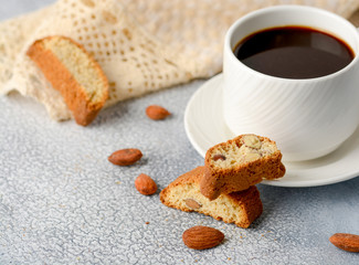 Fototapeta na wymiar Good morning concept - breakfast frothy espresso coffee accompanied by delicious Italian almond cantuccini biscuits