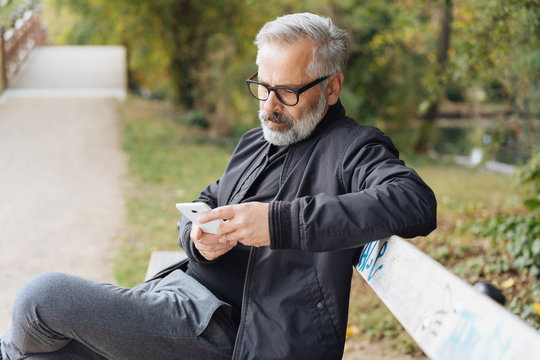 Attractive mature man relaxing on a park bench