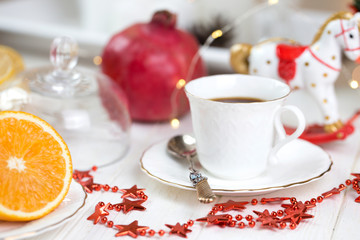  Holidays background with cup of coffee on white wooden table.Cup of Coffee and a Christmas decoration.