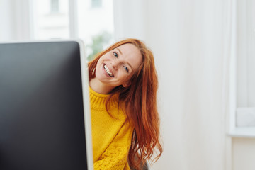 Cute friendly young woman peering at camera