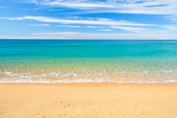 Fototapeta na wymiar Background, Wave foam and blue ocean on the beach.