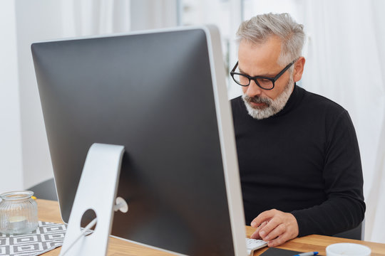 Middle-aged man working in front of computer