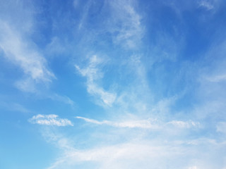 Blue sky with white cirrus clouds on a sunny clear day. Natural background for later design. Weather forecasting for water circulation in the atmosphere. Heaven is a symbol of holiness