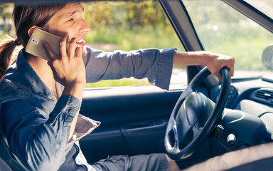 Man talking on phone while driving car.