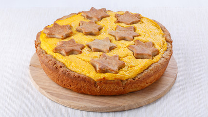 Traditional homemade pumpkin pie on white.