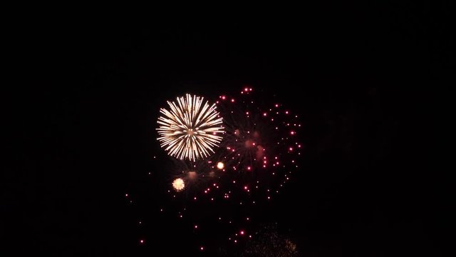 Slow motion fireworks show finale with multiple white stars