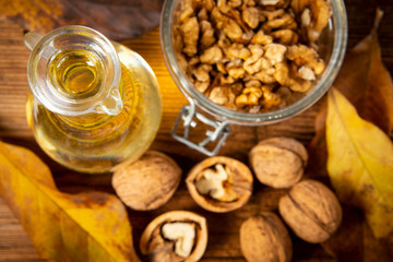 fresh walnuts and oil on an old wooden table