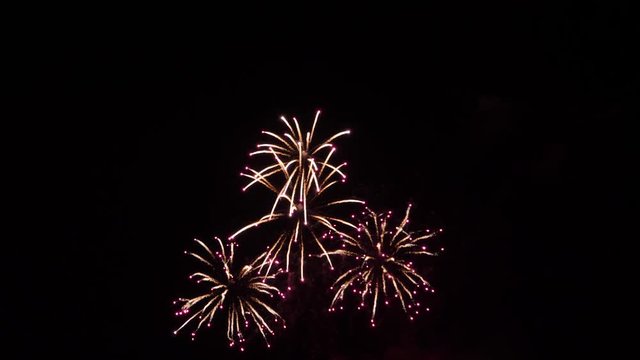 Slow motion fireworks show with white stars and fire flies red