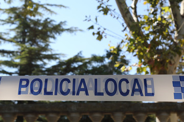 Obraz premium A Spanish police white and blue tape with the Local