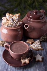 Christmas composition with ginger cookies and a cup of cocoa on the background of spruce branches