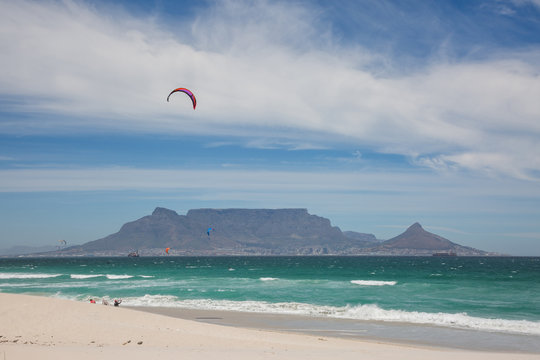 View of Table Mountain from Blouberg Beach with windsurfers
