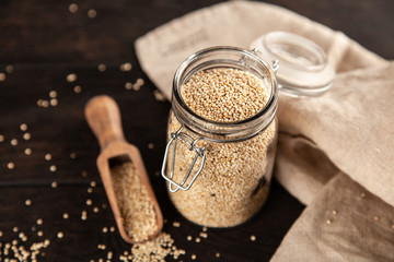 Raw quinoa seeds in a glass jar