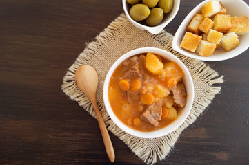 thick Hungarian soup, the goulash. on dark background.