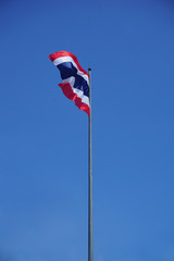 Thailand international flag on top of the pole in blue sky