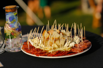 plate with bread, cheese and sausage