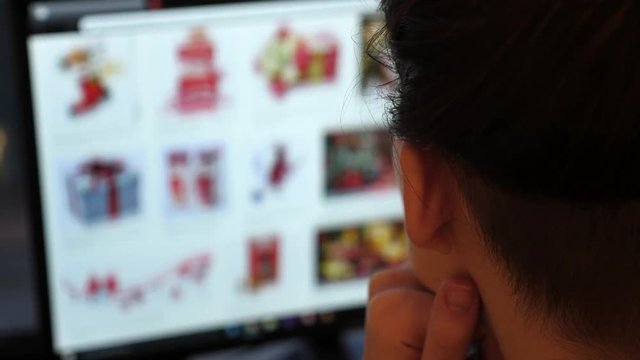 Close-up shot of a woman scrolling web pages and searching for the Christmas gift ideas 
