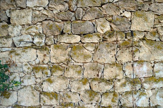 Old Stone wall which is made in a small village.