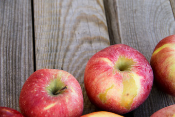 Fresh red apples on wooden table