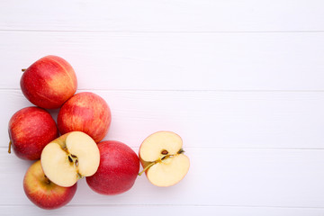Naklejka na ściany i meble Fresh red apples on a white wooden background