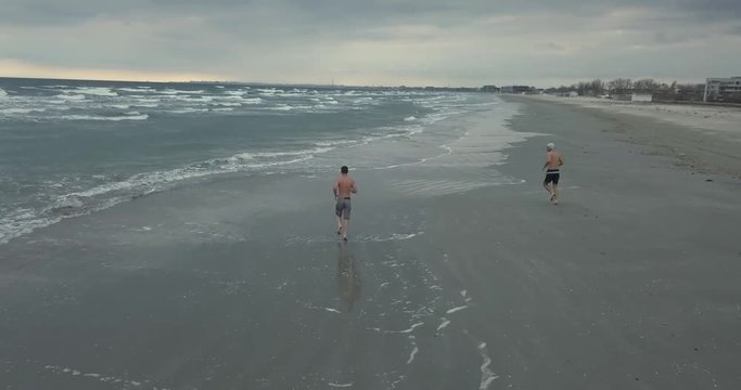 Beach running during the winter in cold water ( Wim Hoff method )